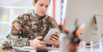 Military person looking at a tablet