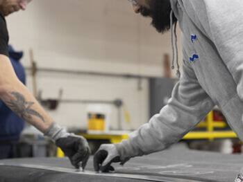 Two Heritage Mechanical employees working on a custom HVAC project